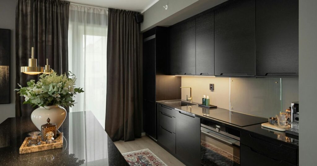 Modern kitchen showcasing sleek black appliances for a bold, stylish look.